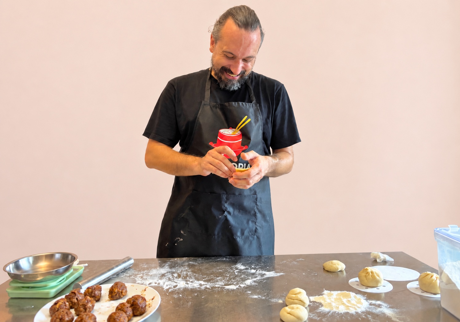 Guest shaping char siu bao during a WOKTOPIA cooking class