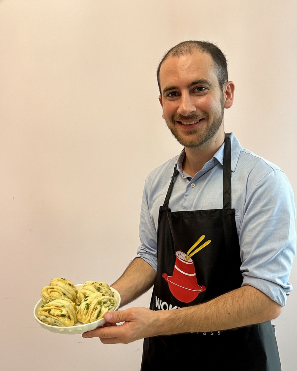 A WOKTOPIA chef-teacher presenting freshly made Cantonese flower rolls