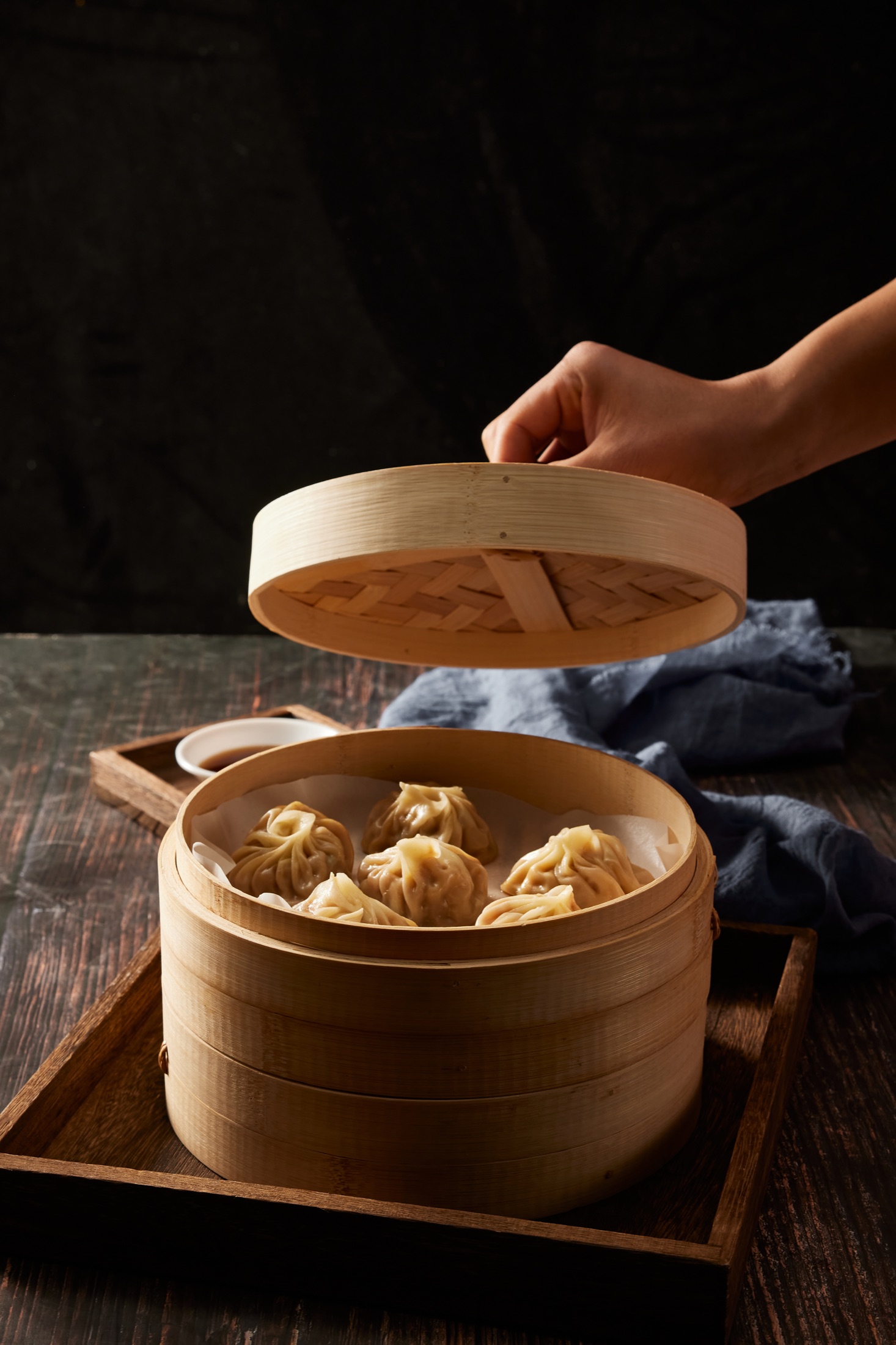 Freshly steamed Cantonese dumplings in a bamboo steamer