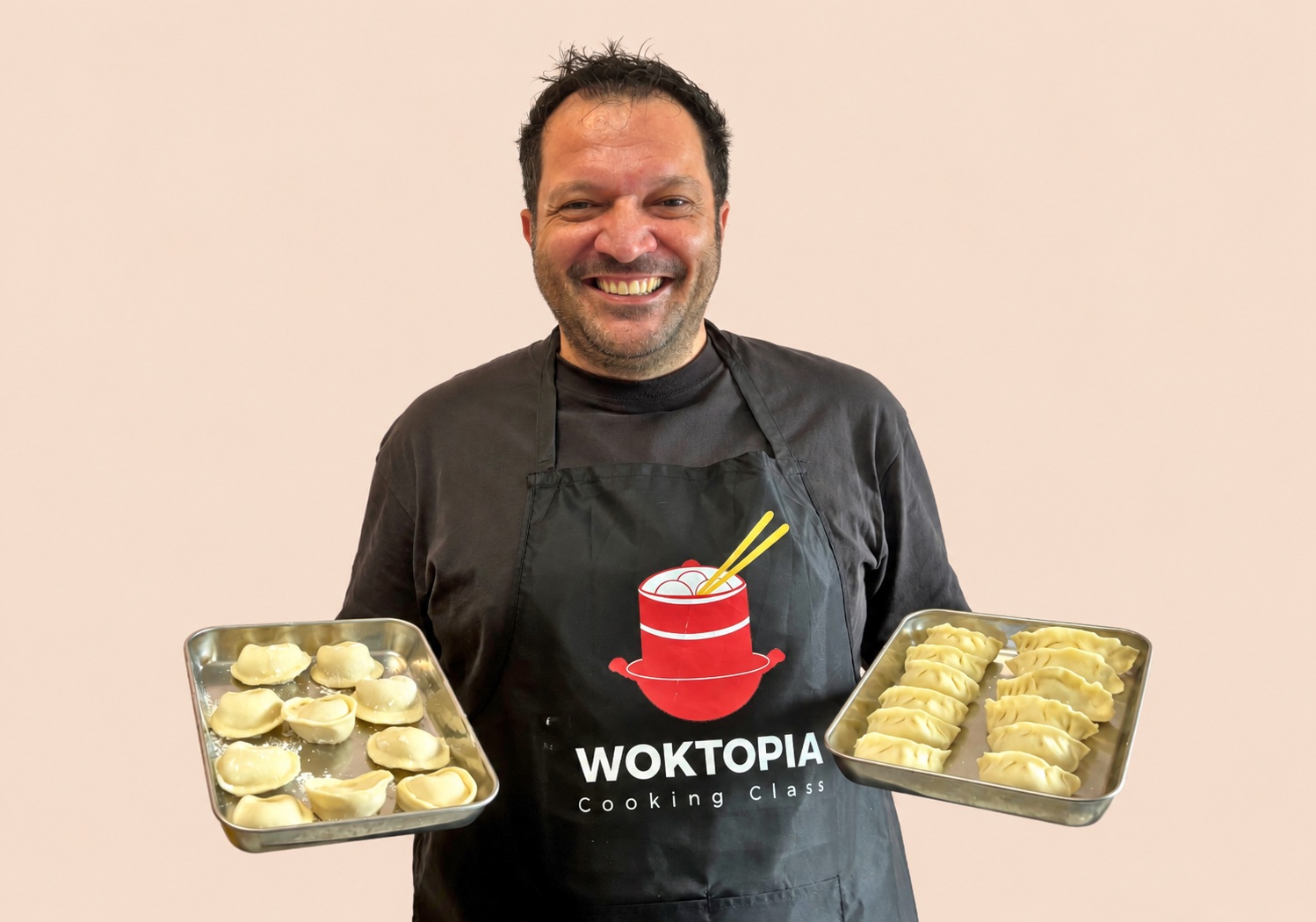 Happy guest showing handmade dumplings at WOKTOPIA Cooking Class