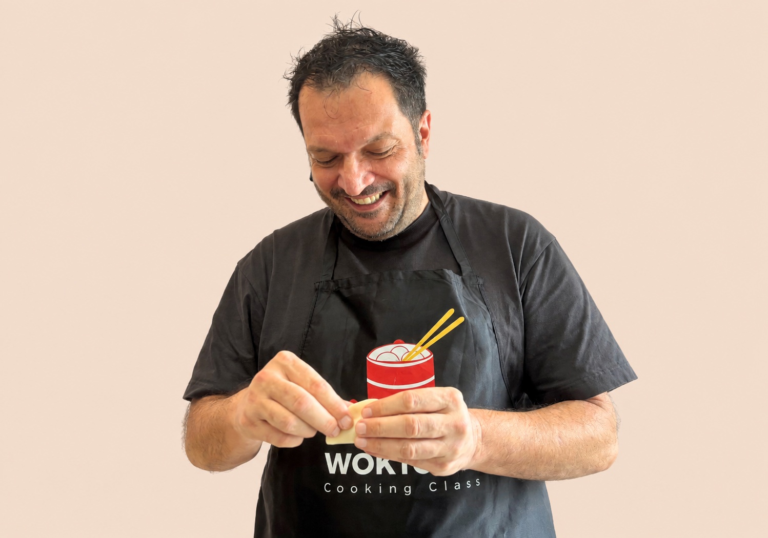 Guest learning to shape dumplings at WOKTOPIA Cooking Class